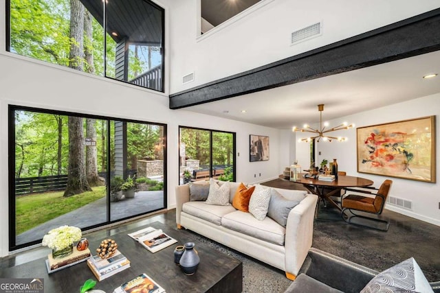 living area with healthy amount of natural light, a chandelier, baseboards, and recessed lighting