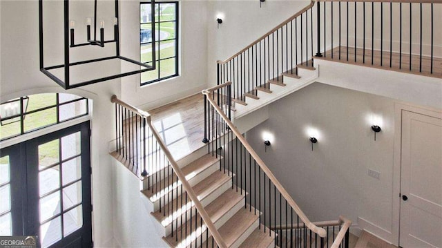 2346 E Maddox Rd, Buford, GA 30518 - stairway with healthy amount of natural light, a high ceiling, and wood finished floors
