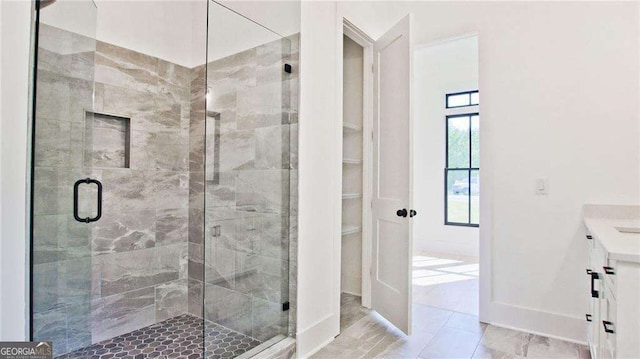 2346 E Maddox Rd, Buford, GA 30518 - full bath featuring a shower stall, vanity, marble finish flooring, and baseboards