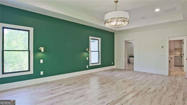 2346 E Maddox Rd, Buford, GA 30518 - unfurnished room with a tray ceiling, light wood-style floors, plenty of natural light, baseboards, and recessed lighting