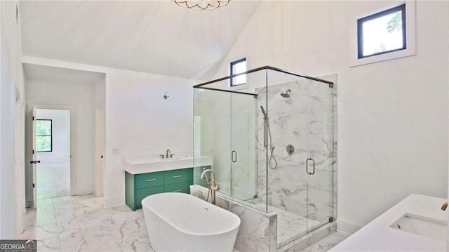 2346 E Maddox Rd, Buford, GA 30518 - full bath featuring marble look tiles, vanity, a freestanding bath, a marble finish shower, and vaulted ceiling