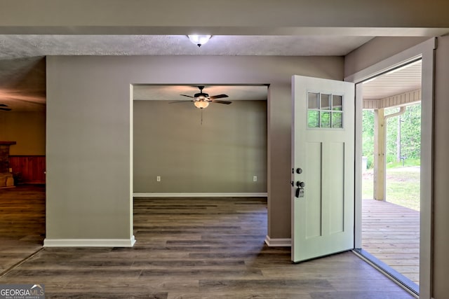 entryway with a ceiling fan, wood finished floors, and baseboards