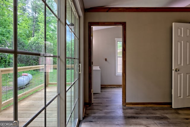 doorway with baseboards and wood finished floors