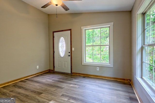 entryway with ceiling fan, baseboards, and wood finished floors