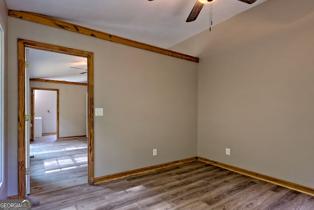 spare room with ceiling fan, wood finished floors, and baseboards
