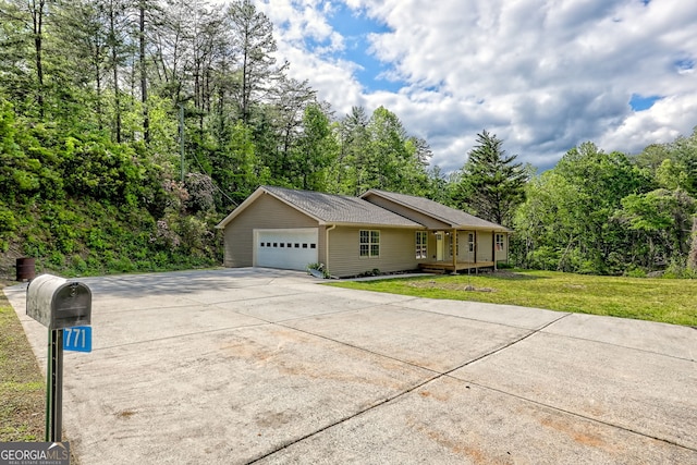 view of home's exterior featuring a lawn, concrete driveway, an attached garage, and a porch