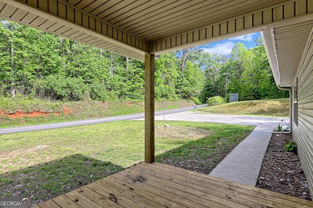 wooden deck featuring a yard
