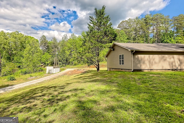 view of property exterior featuring a yard, crawl space, and dirt driveway
