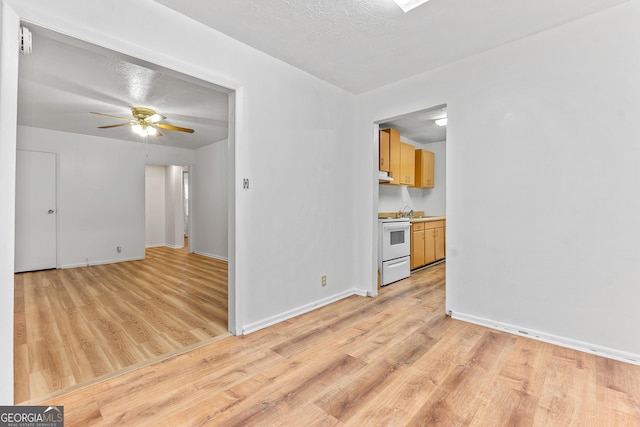 144 Bryant Rd, Cordele, GA 31015 - empty room featuring light wood-style flooring, a ceiling fan, and baseboards