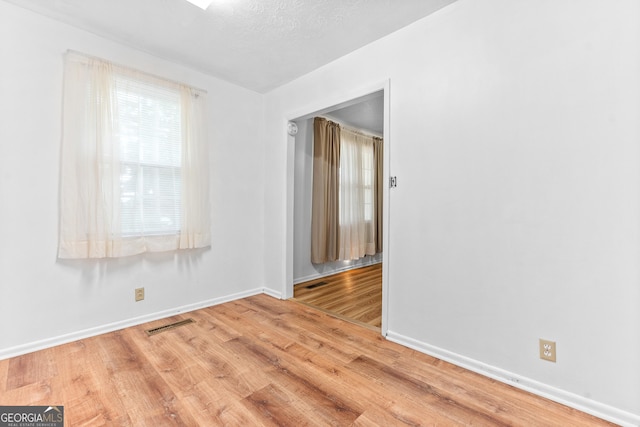 144 Bryant Rd, Cordele, GA 31015 - spare room with wood finished floors, baseboards, and a textured ceiling