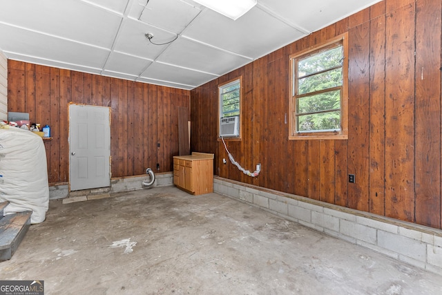 144 Bryant Rd, Cordele, GA 31015 - unfurnished room featuring unfinished concrete floors, wood walls, and cooling unit