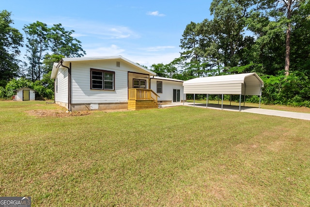 144 Bryant Rd, Cordele, GA 31015 - view of front facade featuring a storage unit, a front yard, a carport, and an outdoor structure