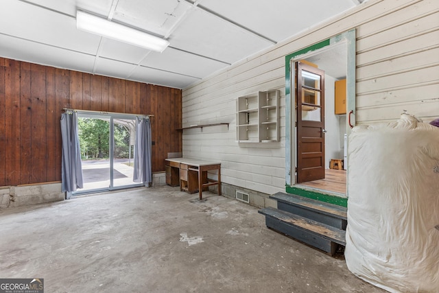 144 Bryant Rd, Cordele, GA 31015 - living area with wood walls and concrete flooring