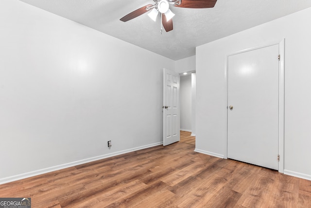 144 Bryant Rd, Cordele, GA 31015 - unfurnished bedroom featuring wood finished floors, baseboards, and ceiling fan