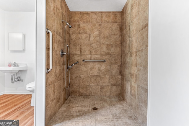 144 Bryant Rd, Cordele, GA 31015 - full bathroom with a tile shower, toilet, and wood finished floors
