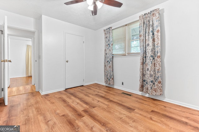 144 Bryant Rd, Cordele, GA 31015 - unfurnished bedroom with wood finished floors, baseboards, and ceiling fan