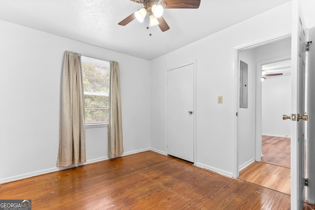 144 Bryant Rd, Cordele, GA 31015 - unfurnished bedroom with electric panel, wood finished floors, baseboards, and a ceiling fan
