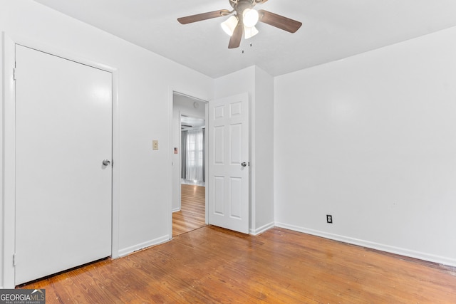 144 Bryant Rd, Cordele, GA 31015 - unfurnished bedroom featuring light wood-style floors, baseboards, and a ceiling fan