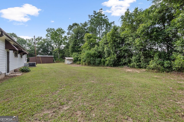144 Bryant Rd, Cordele, GA 31015 - view of grassy yard with a storage shed and an outbuilding