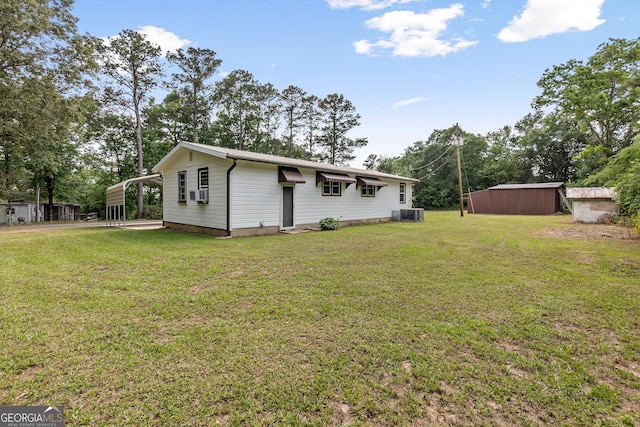 144 Bryant Rd, Cordele, GA 31015 - view of property exterior featuring a lawn, cooling unit, an outdoor structure, and a shed