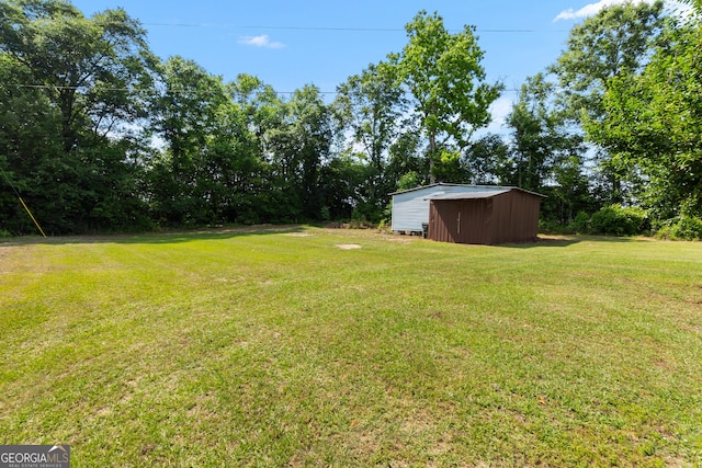 144 Bryant Rd, Cordele, GA 31015 - view of green lawn featuring an outdoor structure and a storage unit