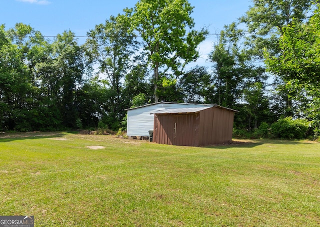 144 Bryant Rd, Cordele, GA 31015 - view of grassy yard featuring an outbuilding and a storage shed