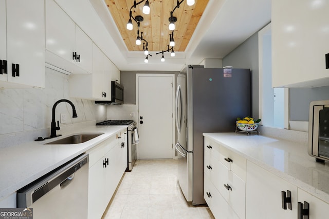 6851 Roswell Rd Unit K-23, Atlanta, GA 30328 - kitchen with stainless steel appliances, wood ceiling, a sink, white cabinetry, and decorative backsplash