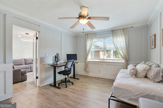 6851 Roswell Rd Unit K-23, Atlanta, GA 30328 - bedroom featuring an office area, ornamental molding, light wood finished floors, a textured ceiling, and a decorative wall