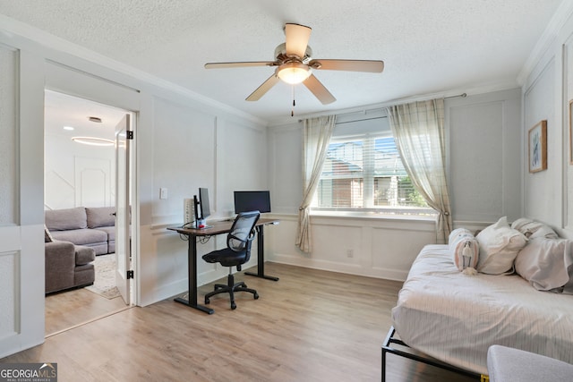 6851 Roswell Rd Unit K-23, Atlanta, GA 30328 - bedroom featuring an office area, ornamental molding, light wood-style flooring, a textured ceiling, and a decorative wall