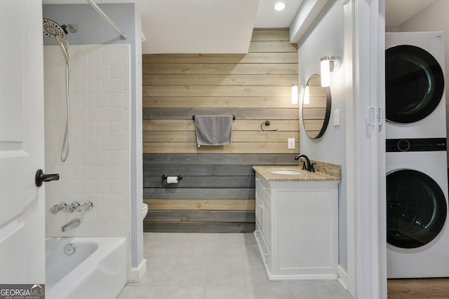 6851 Roswell Rd Unit K-23, Atlanta, GA 30328 - full bathroom featuring estacked washer and dryer, wooden walls, tile patterned flooring, bathing tub / shower combination, and vanity