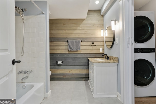 6851 Roswell Rd Unit K-23, Atlanta, GA 30328 - bathroom featuring stacked washer / drying machine, wood walls, tile patterned floors, shower / washtub combination, and vanity