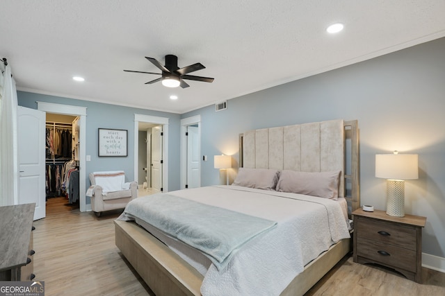 6851 Roswell Rd Unit K-23, Atlanta, GA 30328 - bedroom with ornamental molding, a spacious closet, light wood-style flooring, recessed lighting, and a closet