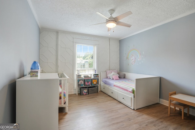 6851 Roswell Rd Unit K-23, Atlanta, GA 30328 - bedroom with ornamental molding, a textured ceiling, light wood-style floors, and ceiling fan