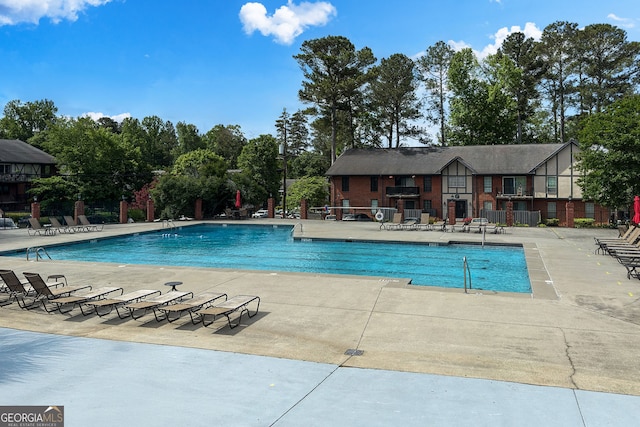 6851 Roswell Rd Unit K-23, Atlanta, GA 30328 - community pool with a patio and view of scattered trees