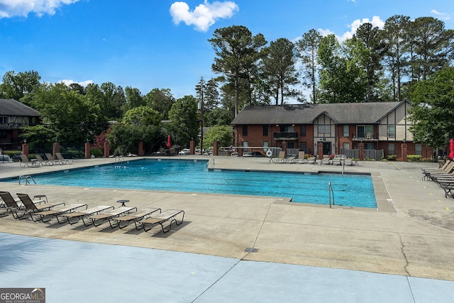 6851 Roswell Rd Unit K-23, Atlanta, GA 30328 - community pool featuring a patio area and view of scattered trees