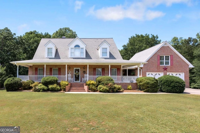 view of front of home with brick siding, a front yard, and covered porch