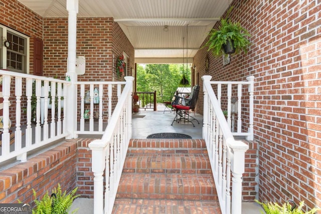 wooden terrace featuring covered porch