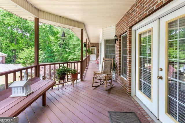 wooden terrace featuring covered porch