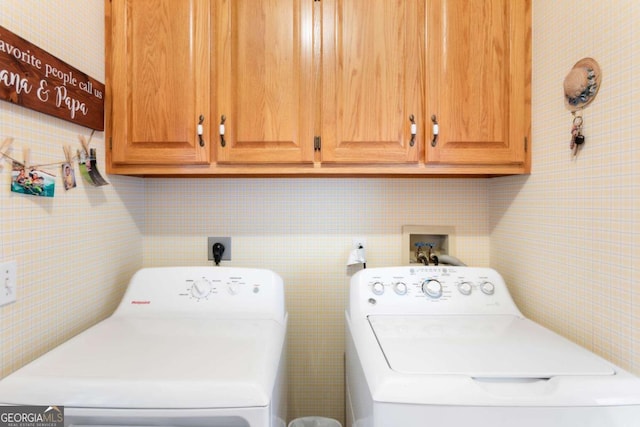 laundry area with washer and clothes dryer, cabinet space, and tile walls
