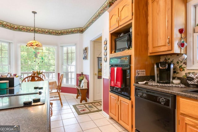 kitchen with black appliances, dark countertops, pendant lighting, and light tile patterned floors