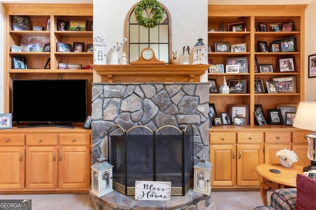 living area featuring a fireplace and carpet