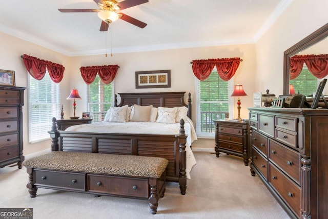 bedroom featuring light colored carpet, crown molding, ceiling fan, and baseboards