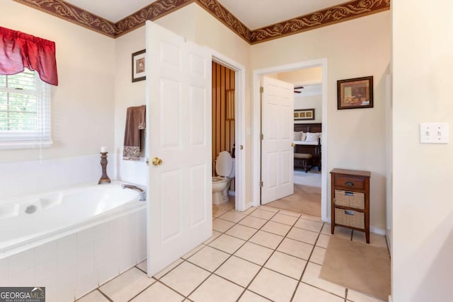 full bathroom featuring tile patterned flooring, a bath, and toilet