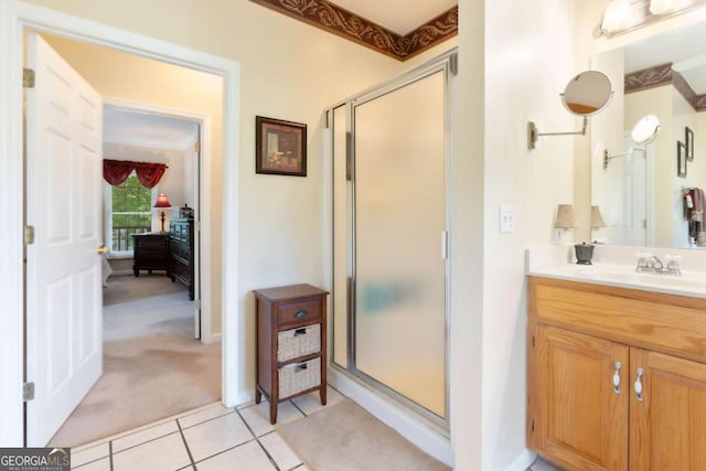 full bathroom featuring a stall shower, vanity, tile patterned flooring, and baseboards