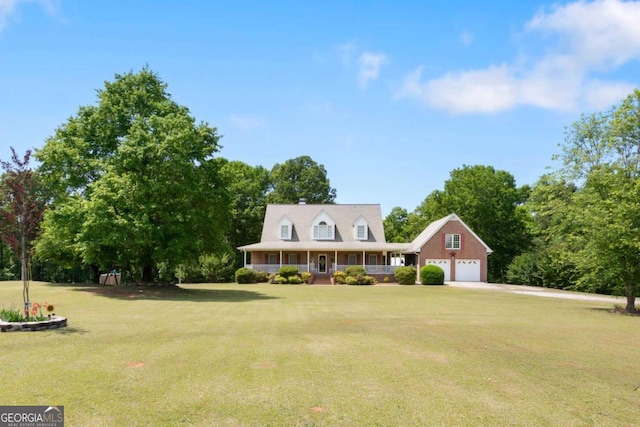 farmhouse-style home with a front yard, a porch, concrete driveway, and an attached garage