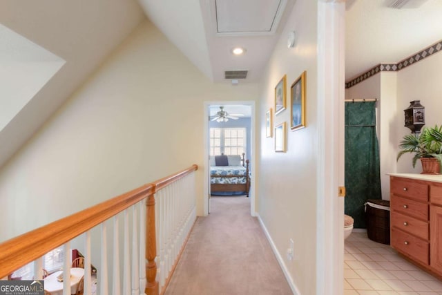 hallway featuring attic access, lofted ceiling, and recessed lighting