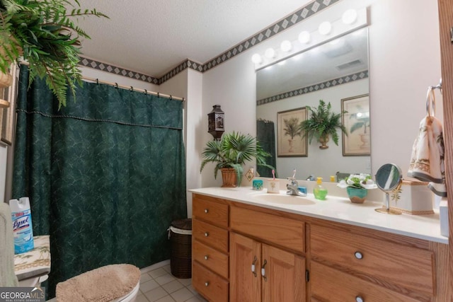 bathroom featuring vanity, tile patterned flooring, and a textured ceiling