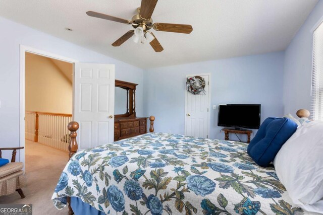 bedroom featuring carpet flooring, vaulted ceiling, and a ceiling fan
