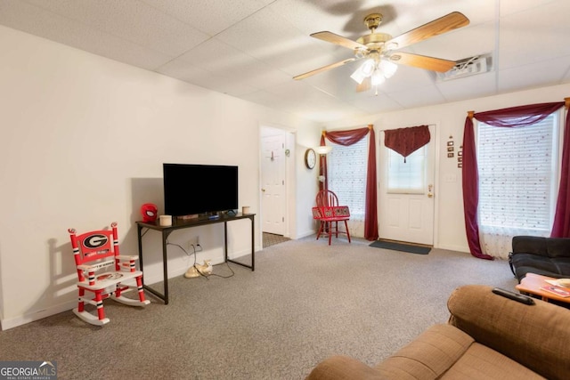 living room featuring ceiling fan, carpet floors, and baseboards