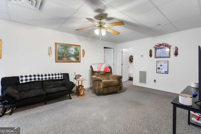carpeted living room with a paneled ceiling, ceiling fan, and baseboards